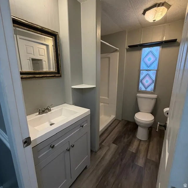 Bathroom featuring a neutral-toned vanity with an integrated sink, polished chrome faucet, and a decorative framed mirror.  this leads into the laundry room