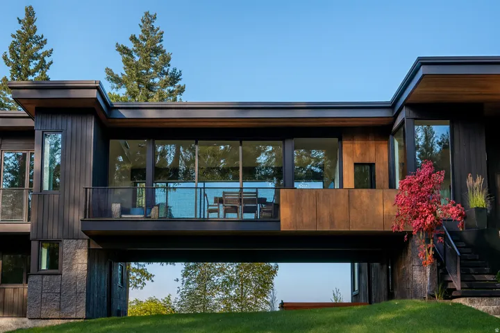 House is not on the property.  This image is a representation of a designed house solution that has already been building permitted. Potential architectural design featuring expansive glass panels, a private balcony with glass railing, concrete and wood-f