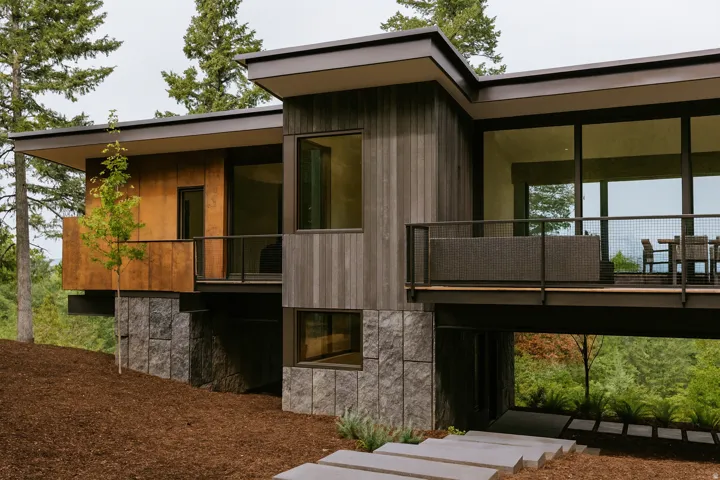 House is not on the property.  This image is a representation of a designed house solution that has already been building permitted. Rear view of potential modern house.  Modern architecture featuring multiple balconies and expansive windows.