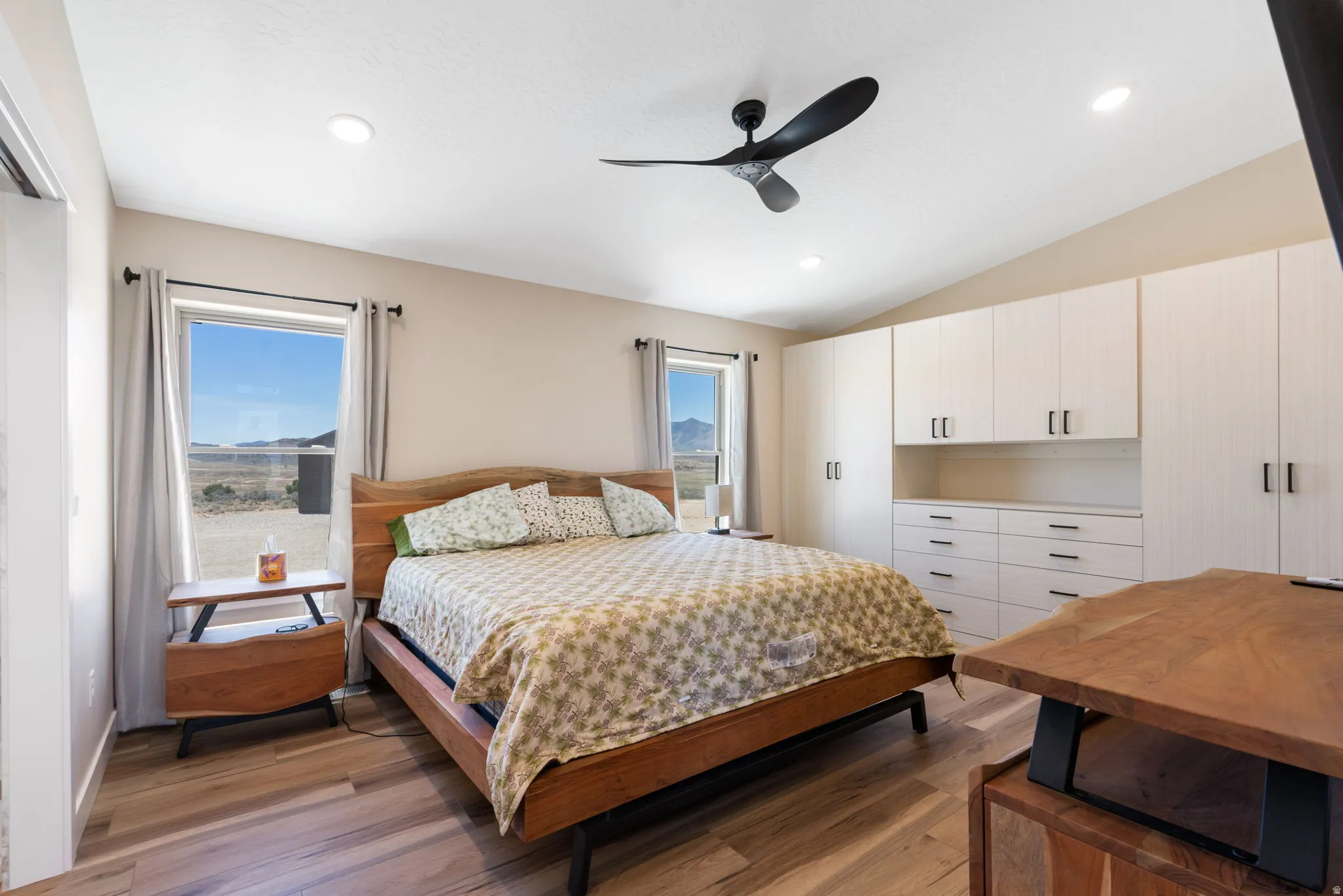 Bedroom featuring wood-finish flooring, vaulted ceiling, and recessed lighting