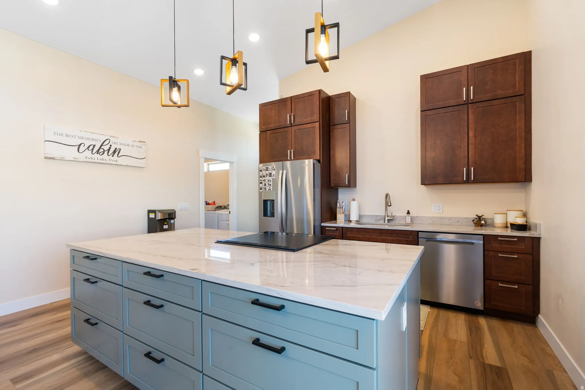Kitchen featuring a large central island with a light-colored countertop and light blue cabinetry