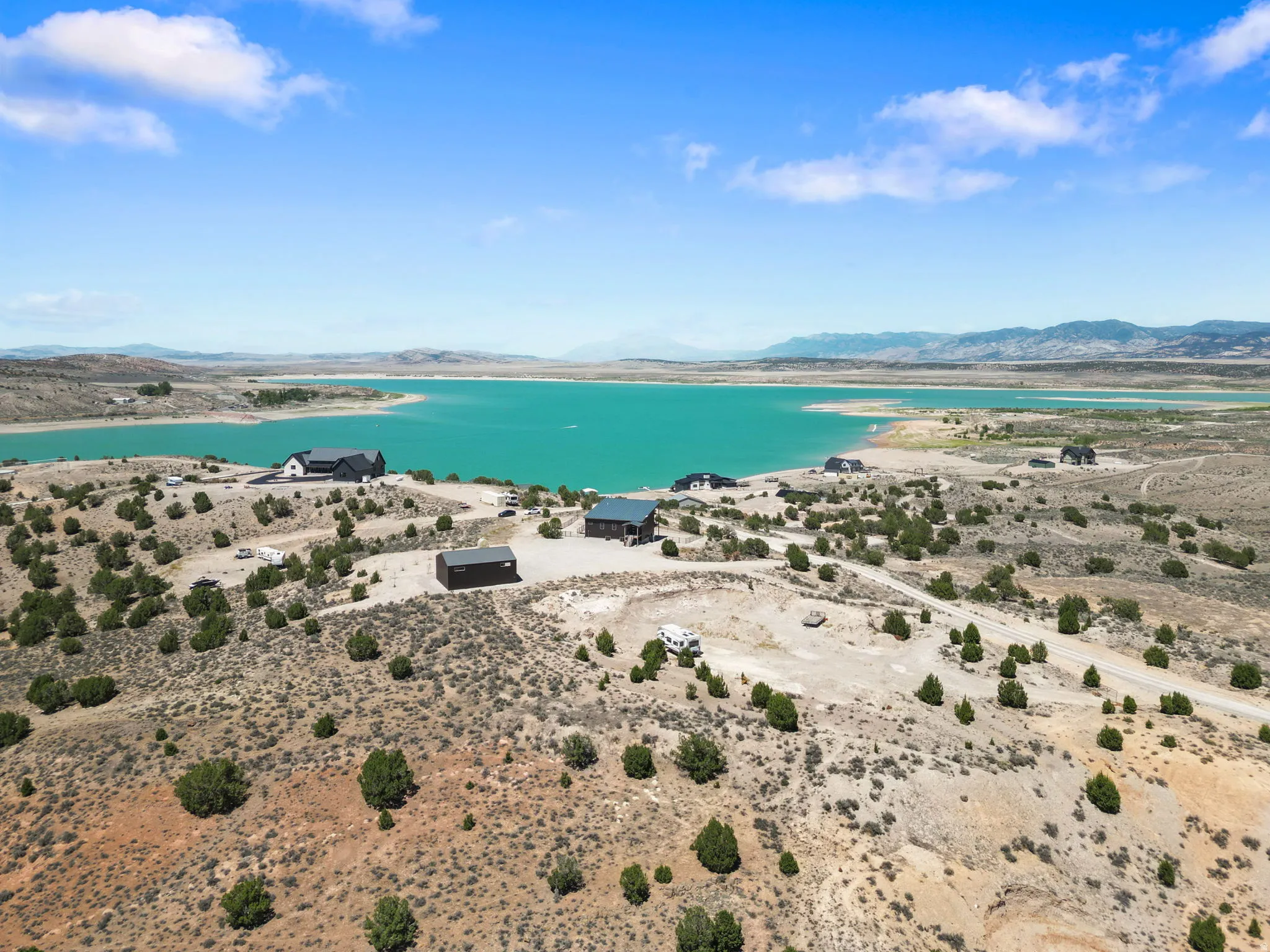 Elevated property featuring a water body, mountainous backdrop, and natural desert landscaping