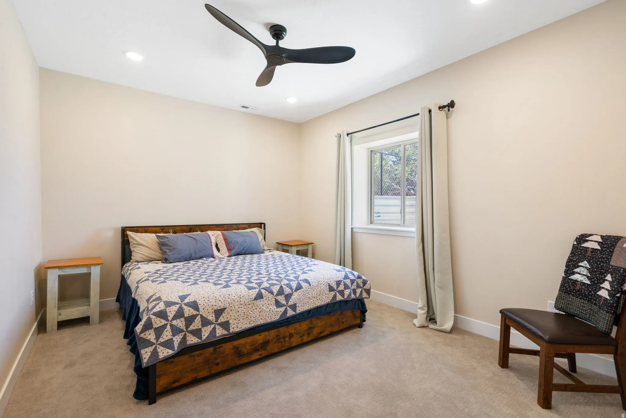 Spacious room featuring neutral-toned walls, recessed lighting, and a modern ceiling fan