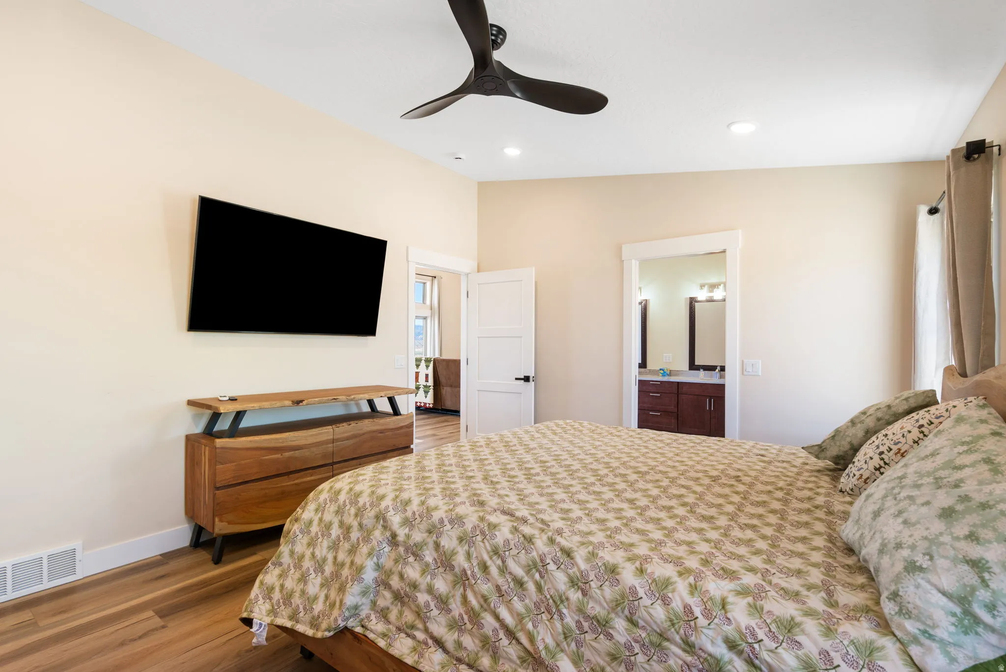 Bedroom featuring wood-finish flooring, recessed lighting, and a contemporary ceiling fan