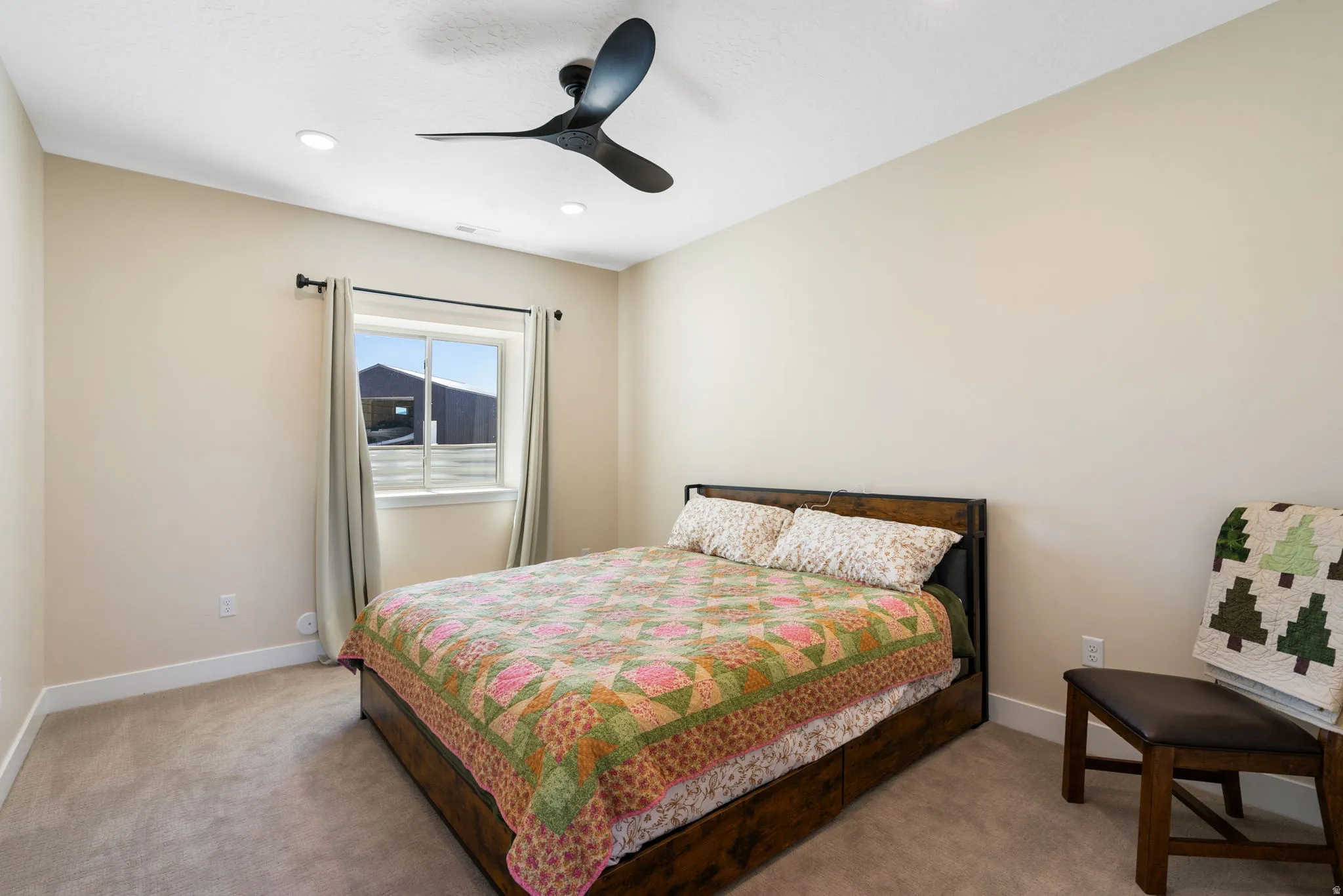 Neutral tone walls complement the carpeted flooring