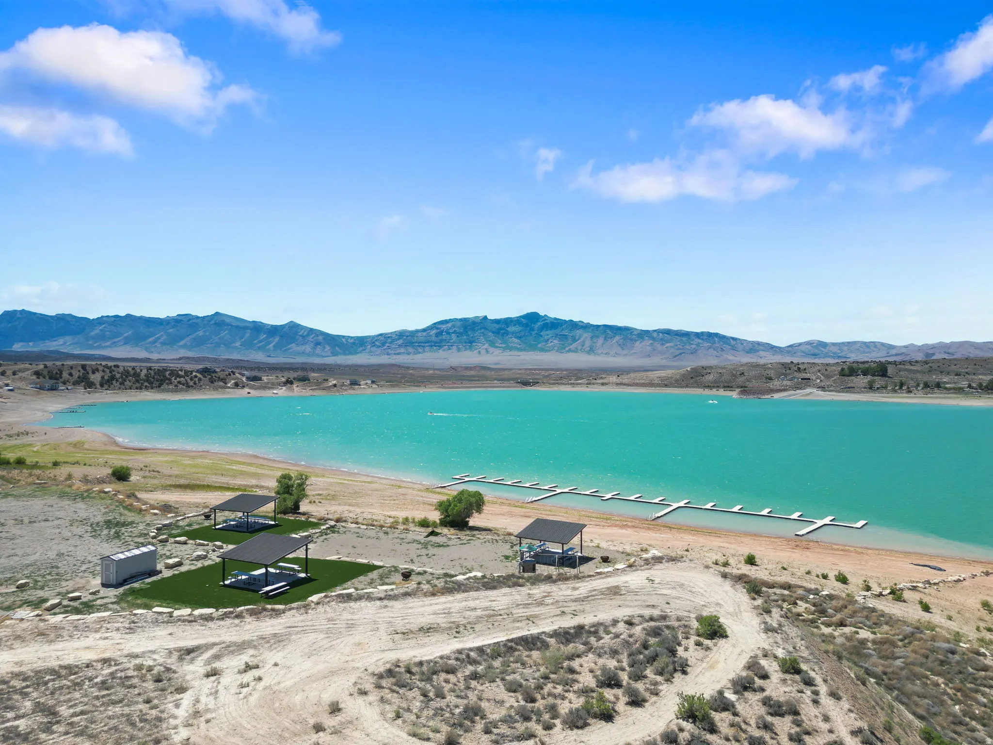 Waterfront setting featuring a large body of water, extensive shoreline, and distant mountains