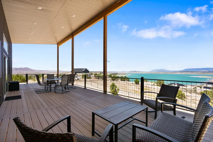 Expansive covered deck featuring composite decking and a black metal railing system