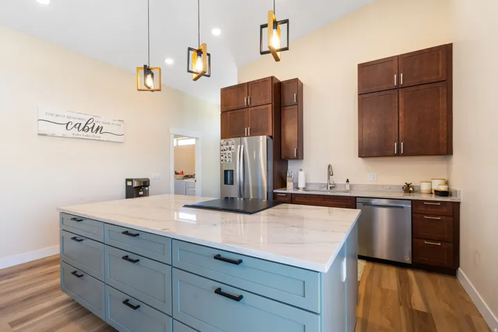 Kitchen featuring a large central island with a light-colored countertop and light blue cabinetry