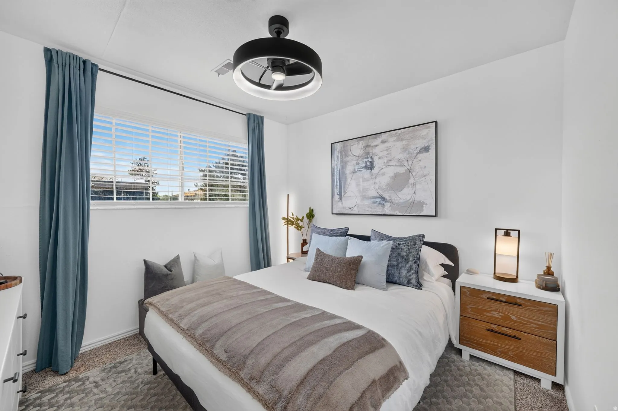 Bright interior space featuring a multi-pane window, white walls, and a contemporary ceiling fan with integrated lighting