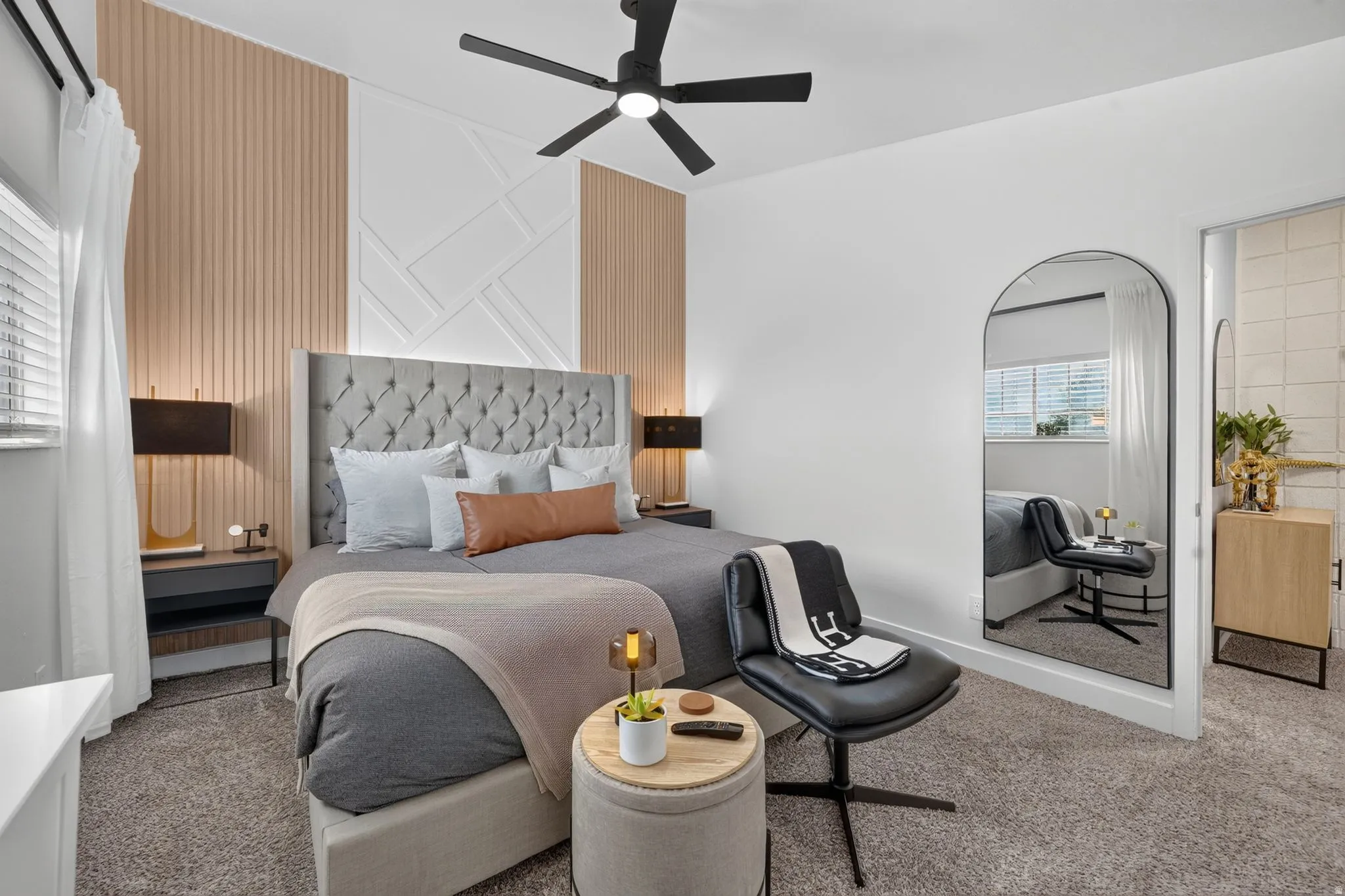Plush carpeting and a contemporary ceiling fan define this space