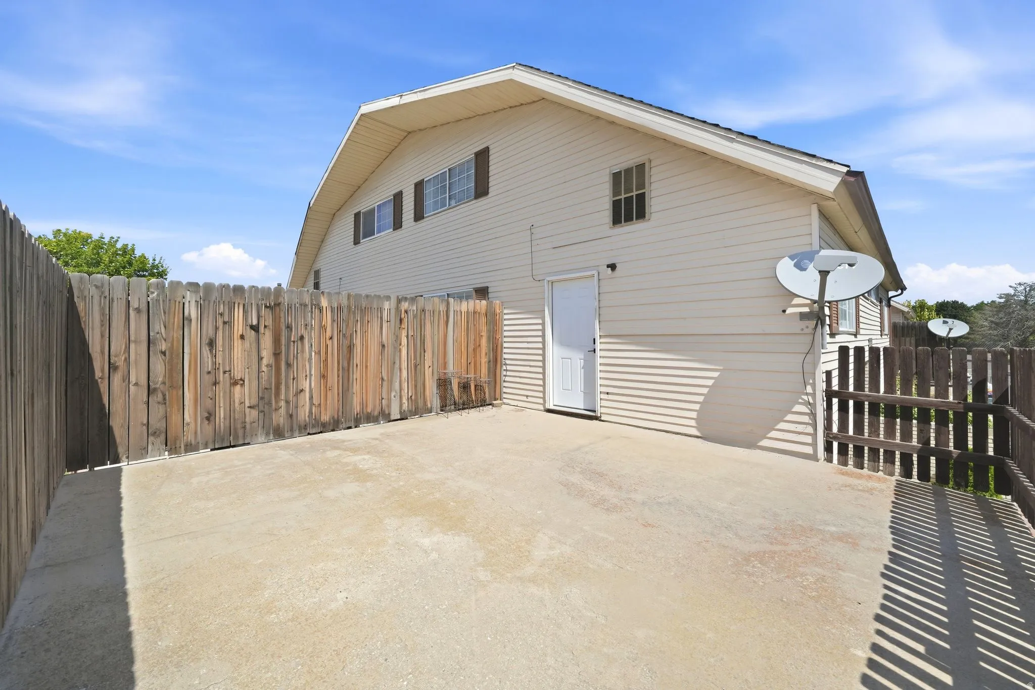Concrete patio area with wood privacy fencing