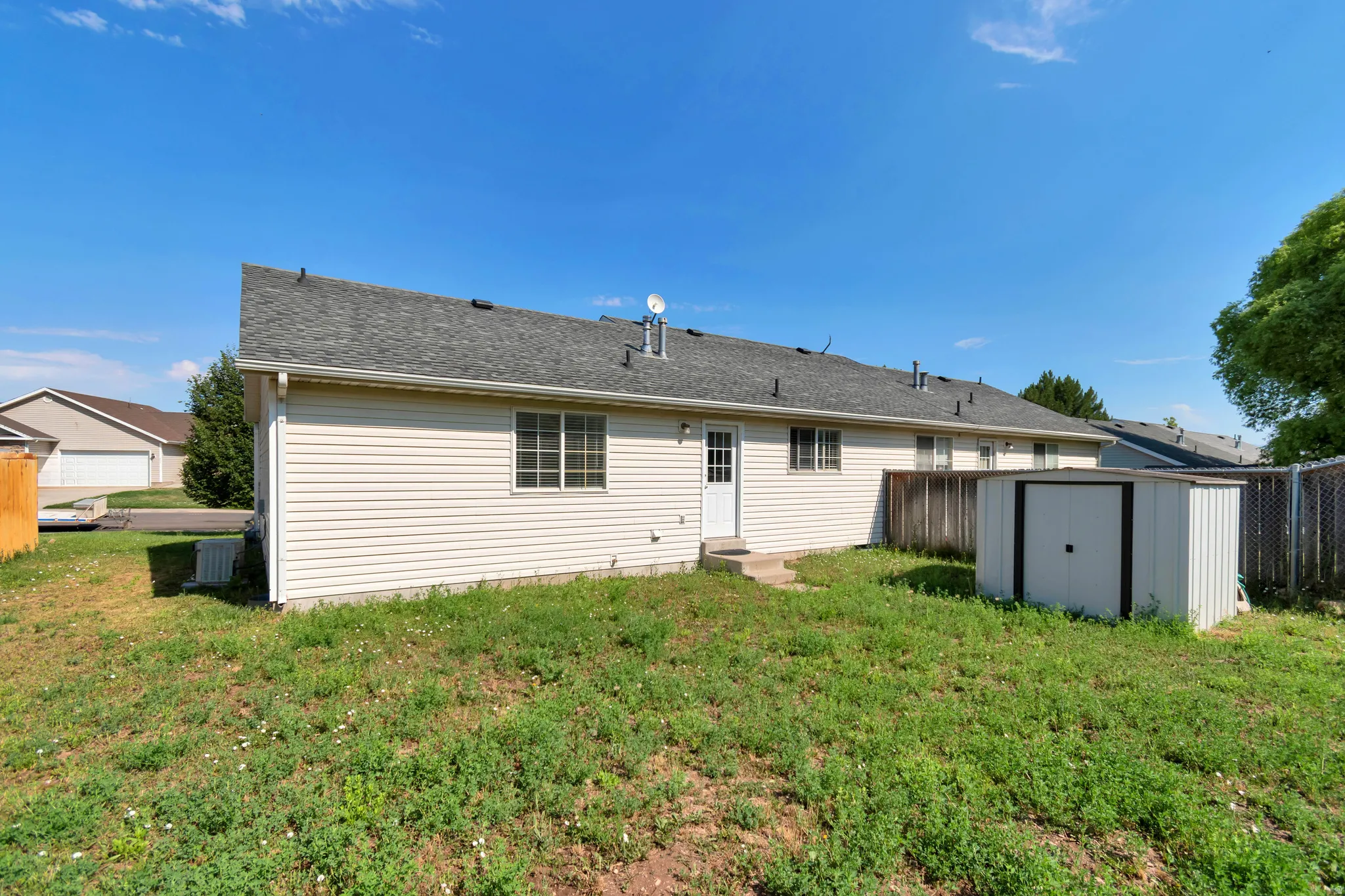 Rear exterior featuring horizontal siding, a gabled roofline, and multiple windows