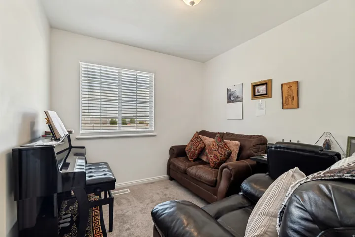 Neutral-toned walls complement the carpeted flooring
