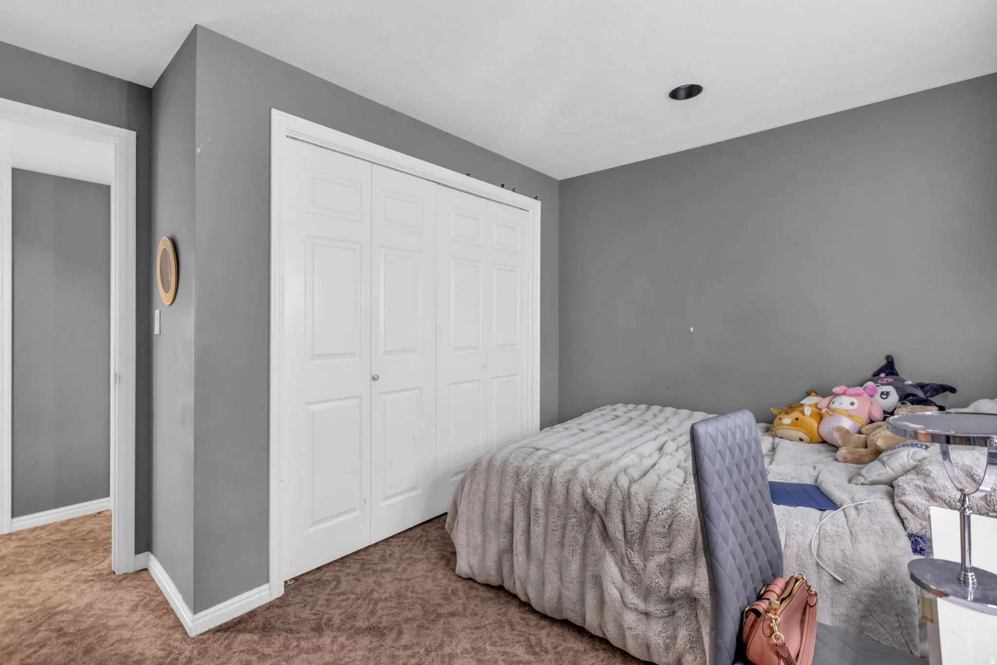Spacious interior with gray walls and brown carpet flooring