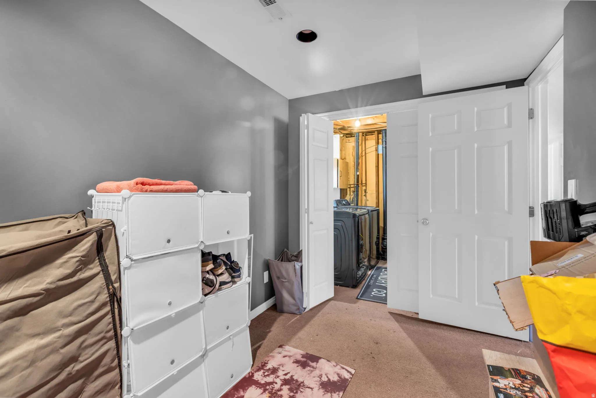 Gray painted interior with recessed lighting and neutral carpeting