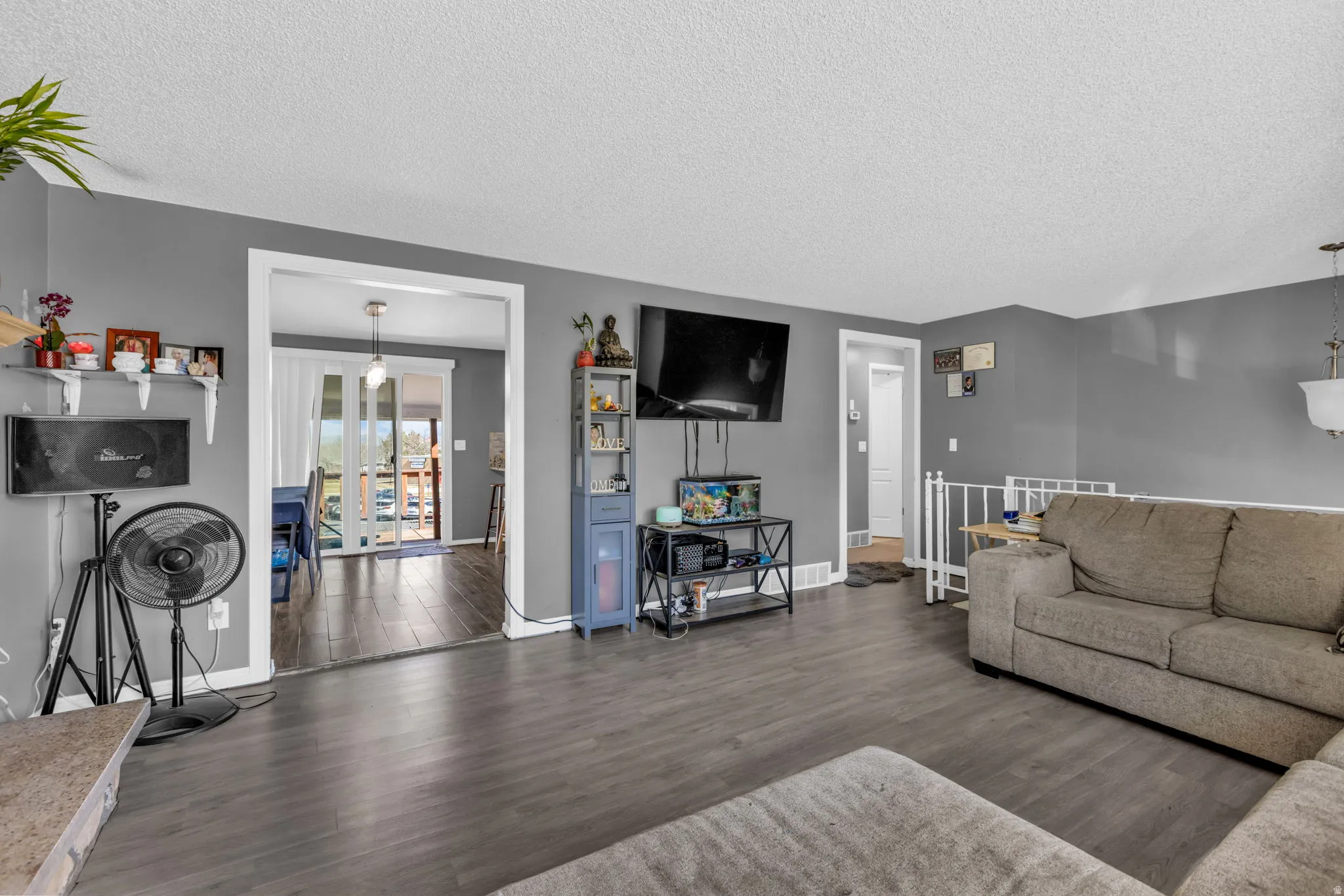 Spacious interior featuring dark wood-finish flooring, a neutral wall palette, and white trim