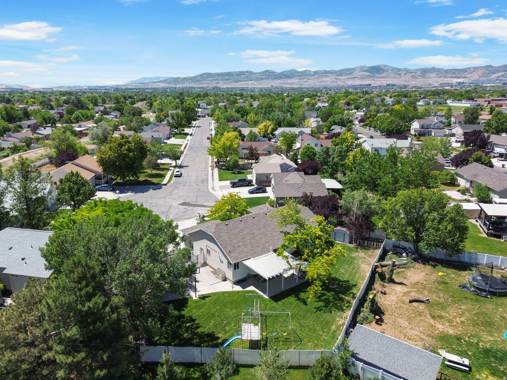 Aerial perspective featuring a residential neighborhood with distant mountains