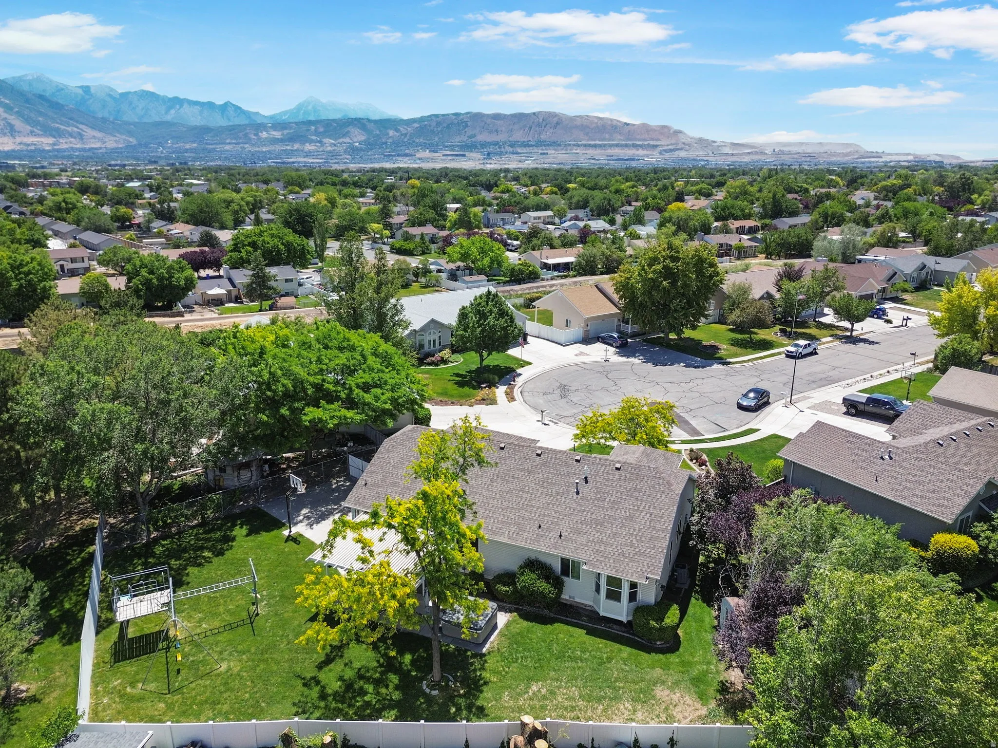 Aerial perspective showcasing a residential neighborhood with distant mountain ranges