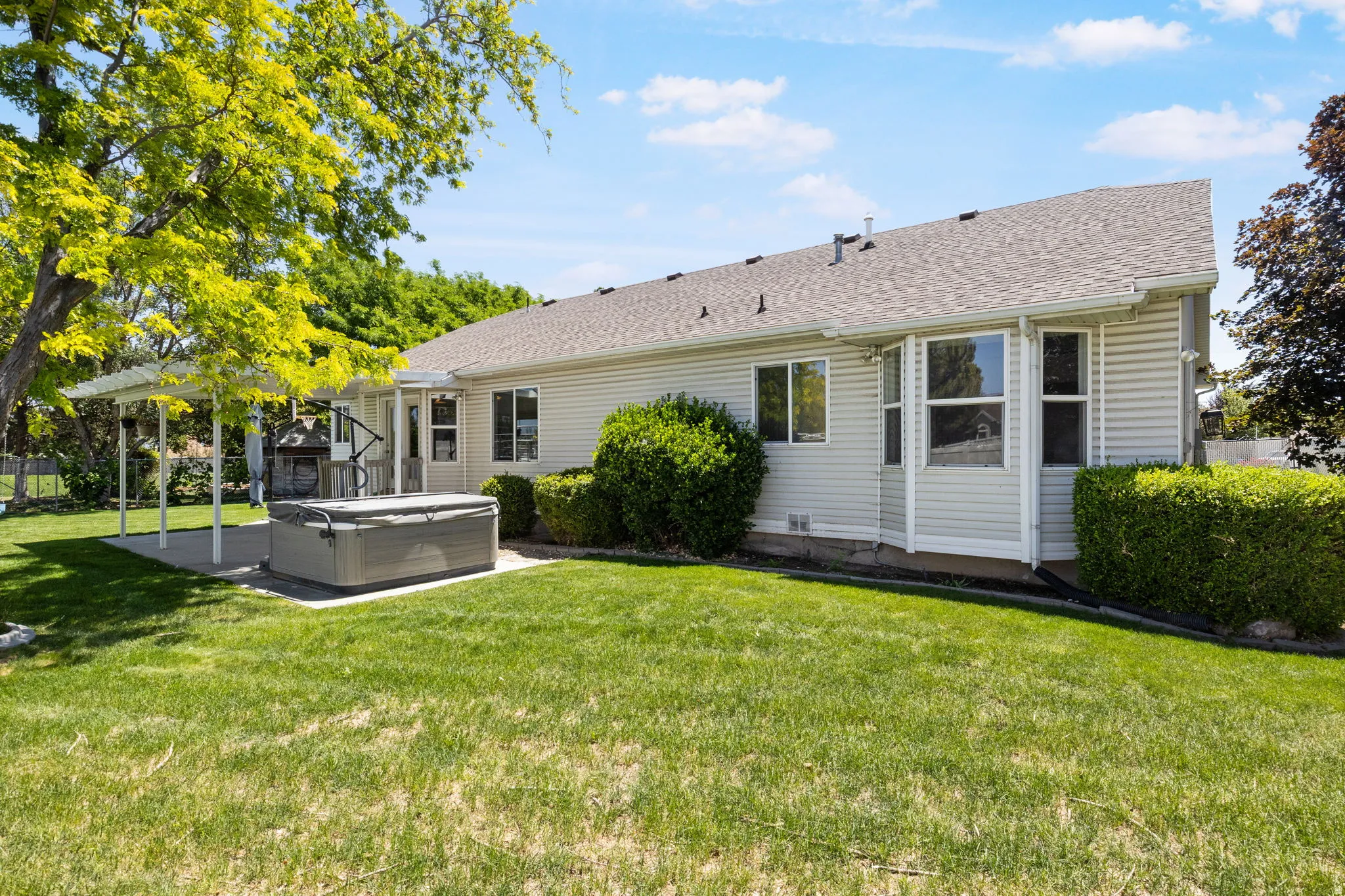 Expansive backyard featuring a large lawn area and established landscaping
