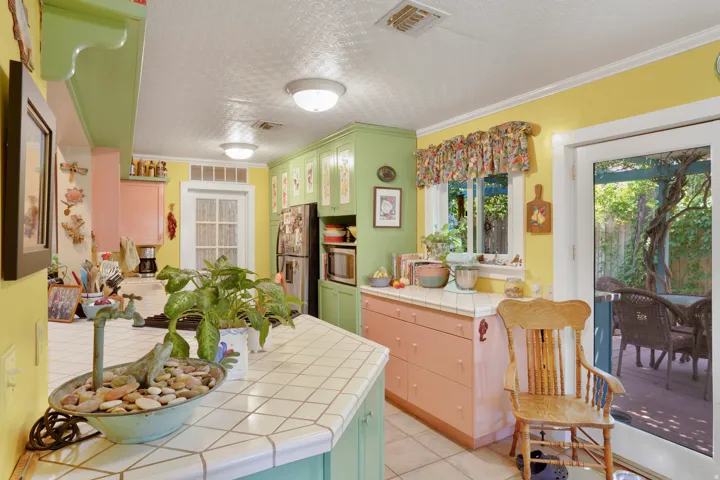 Kitchen featuring tile countertops, pastel cabinetry, and recessed lighting