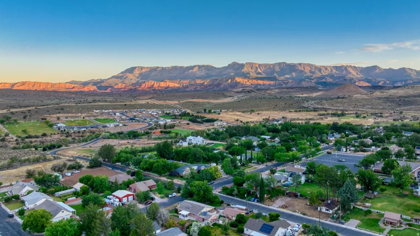 Expansive aerial landscape highlighting a developed residential community with established trees and street grids