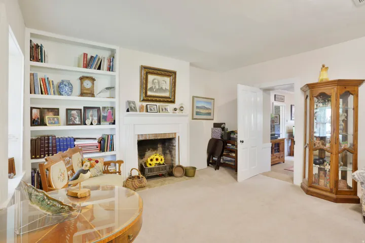 Living area with light-toned carpeting and neutral wall finishes