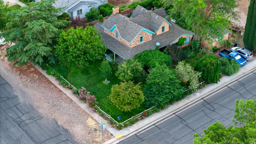 Stone and stucco exterior residence featuring a grey shingle roof