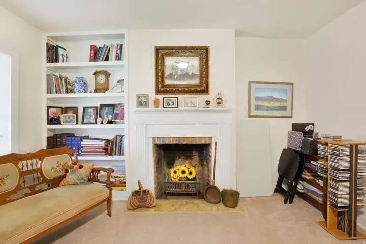 Fireplace featuring a brick firebox and a white mantel
