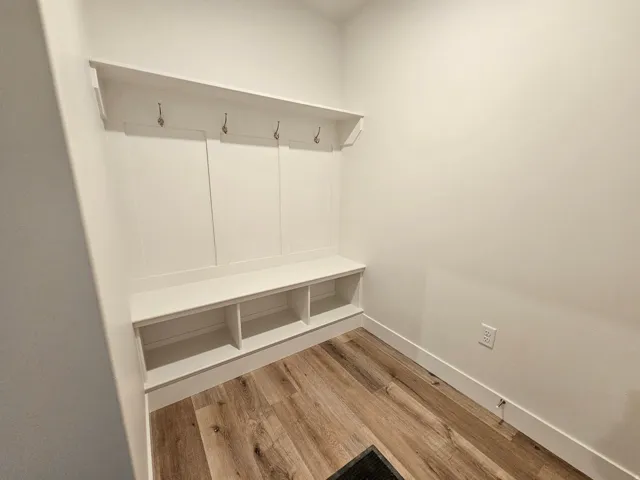 Built-in mudroom bench with storage cubbies and wall-mounted hooks