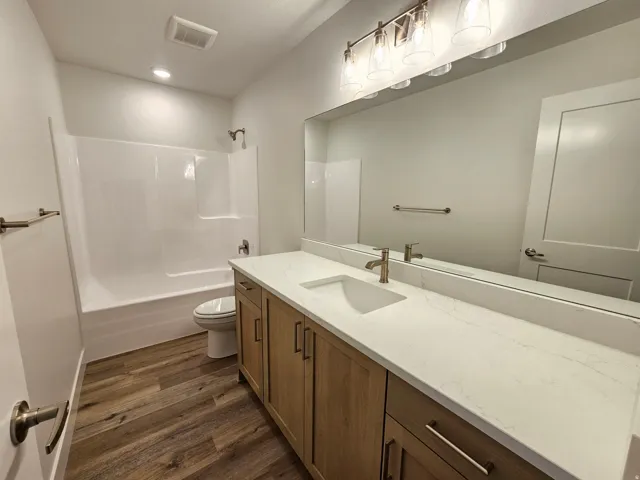 White solid surface countertop with integrated rectangular sink and brushed nickel faucet
