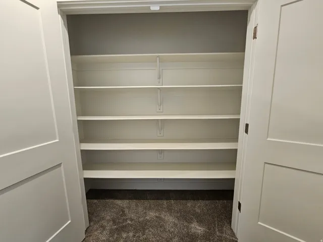 Built-in white shelving system with six shelves