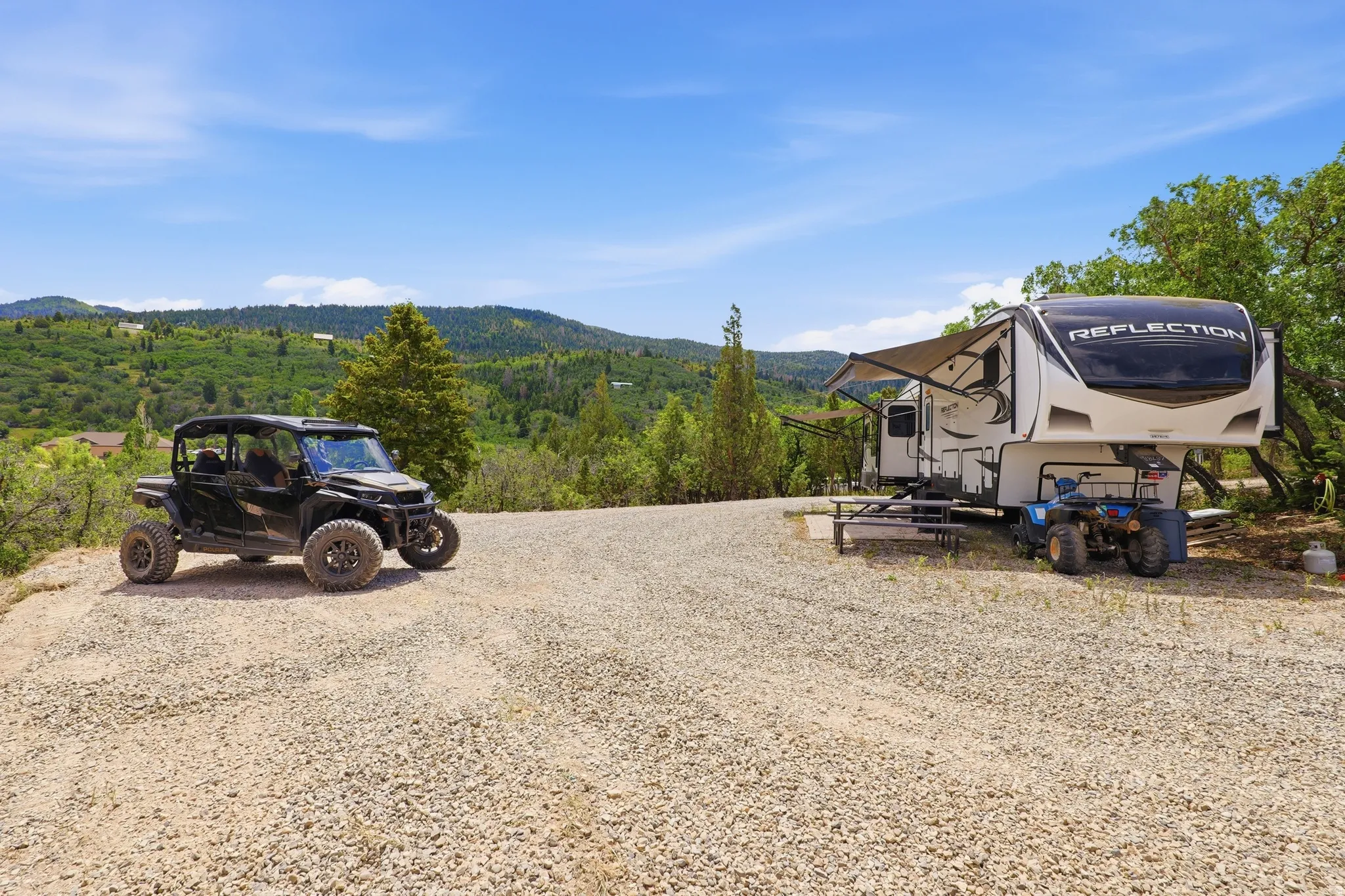 Expansive gravel pad offering ample parking and space for recreational vehicles