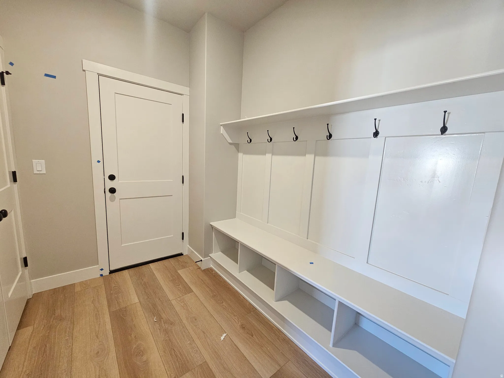 Built-in mudroom bench with integrated cubbies and upper storage shelf