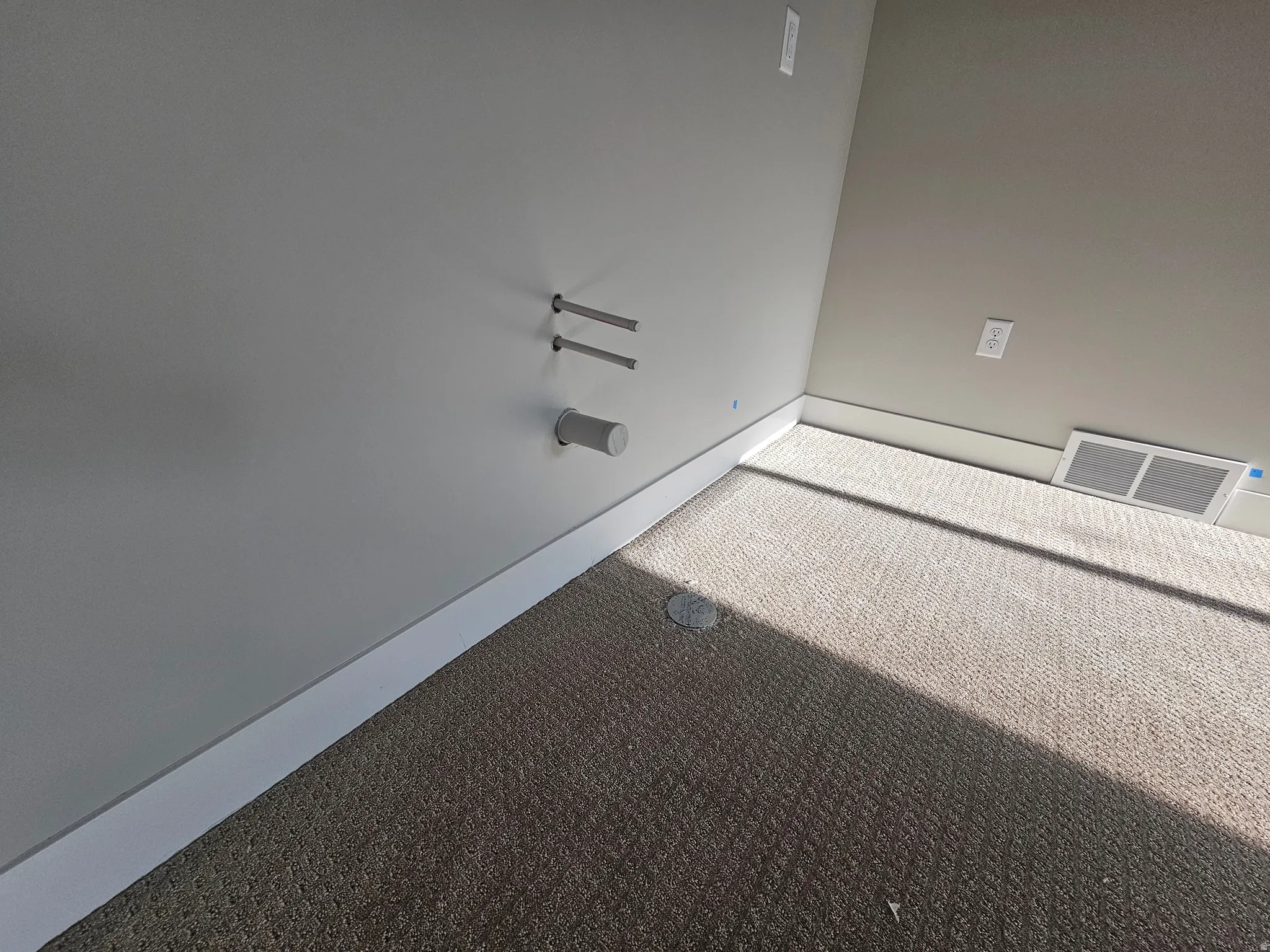 Textured wall-to-wall carpeting with white baseboards