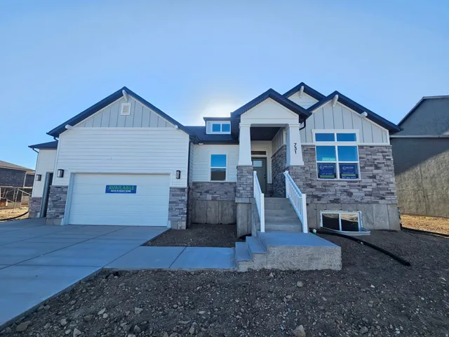 Contemporary home with white siding and stone veneer accents