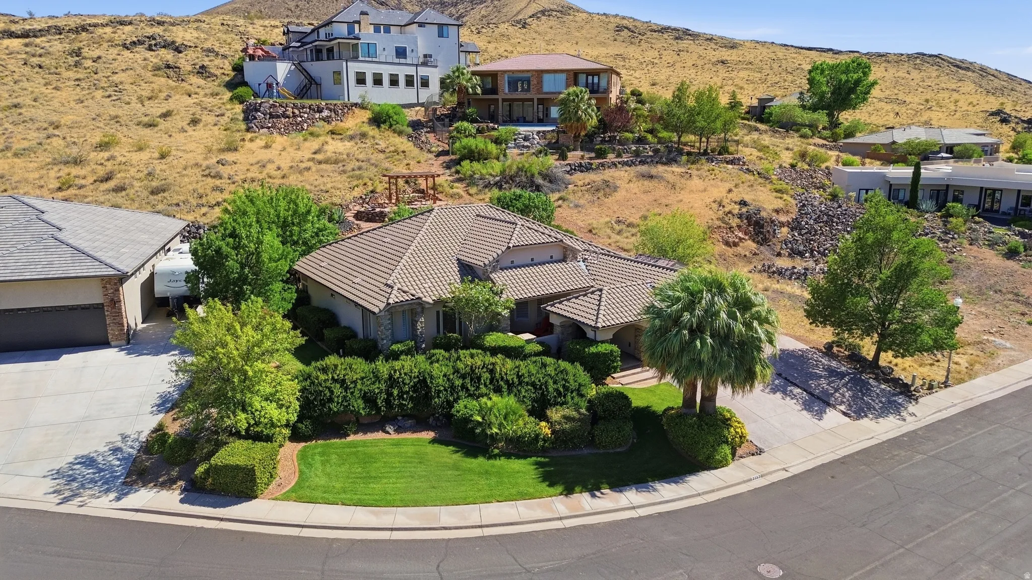 Stucco exterior residence with a tiled roof, featuring an integrated two-car garage