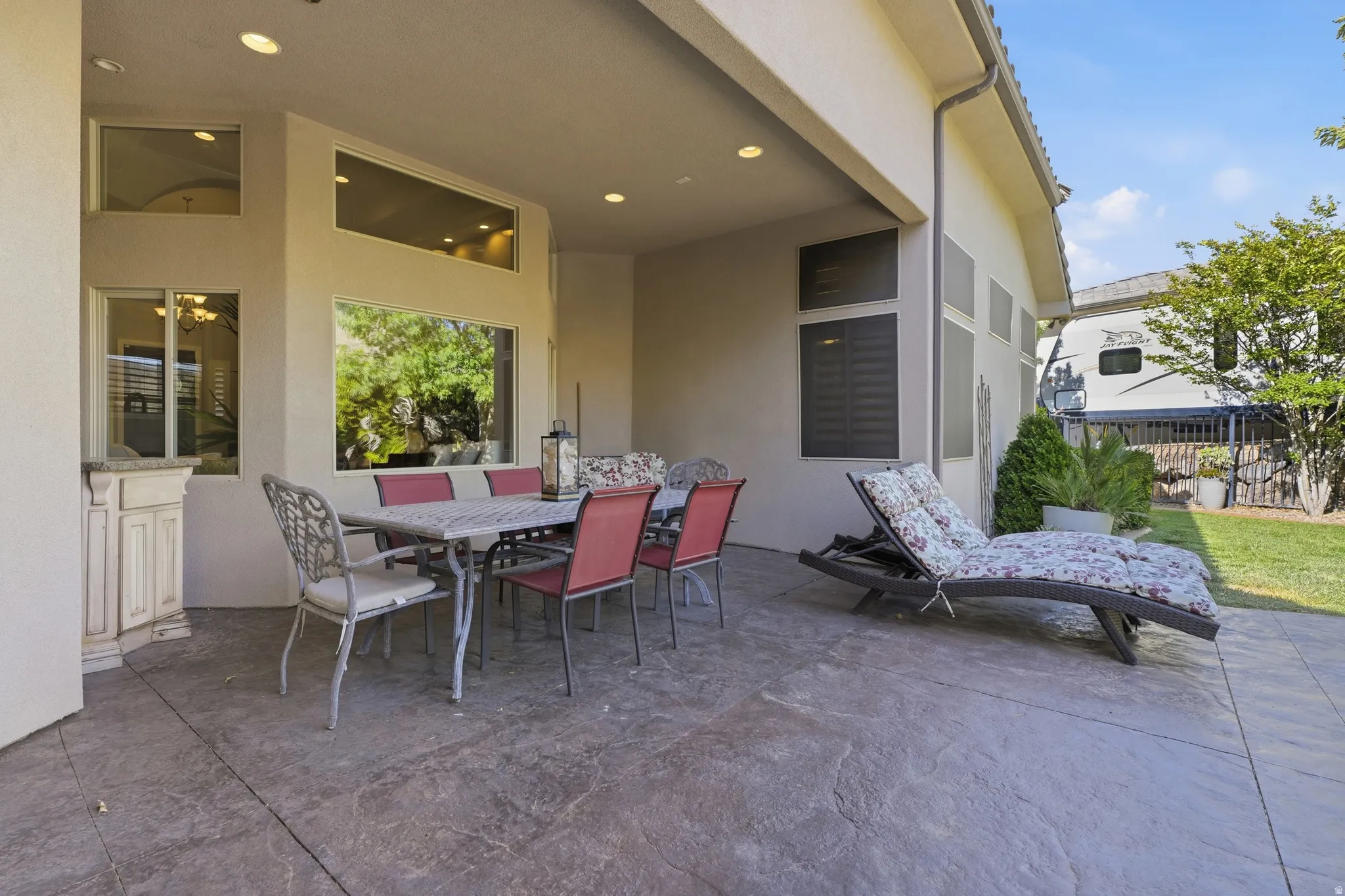 Expansive covered patio featuring a stamped concrete surface and recessed lighting