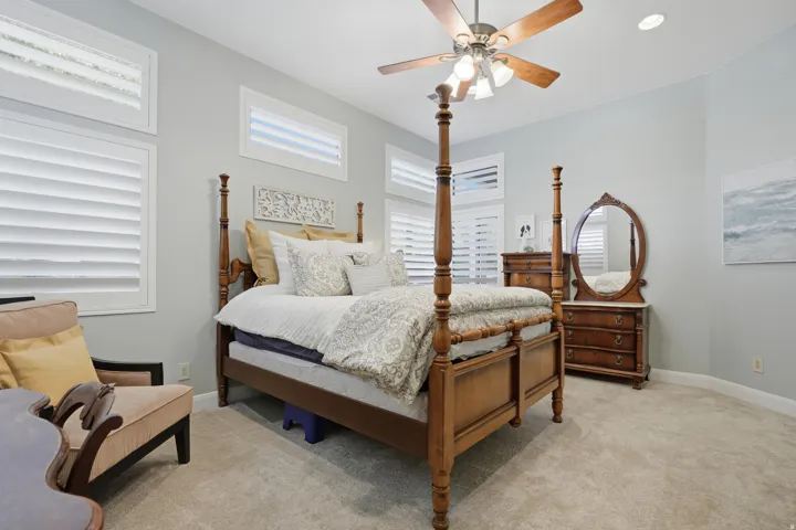 Spacious room featuring light gray wall paint and beige carpet flooring