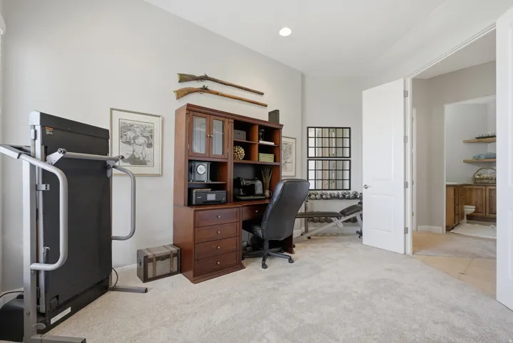 Versatile room featuring light-toned carpeting and neutral wall paint