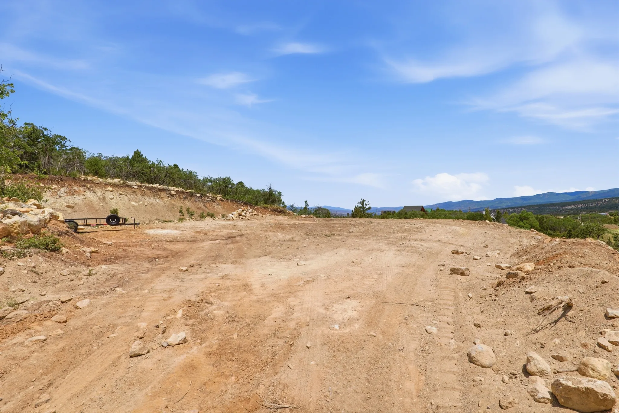 Expansive cleared lot featuring level ground and distant mountain scenery