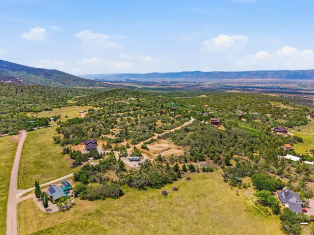 Expansive landscape featuring scattered residential properties, mature trees, and natural terrain