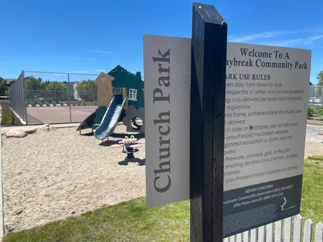Community park playground featuring a slide and sand play area