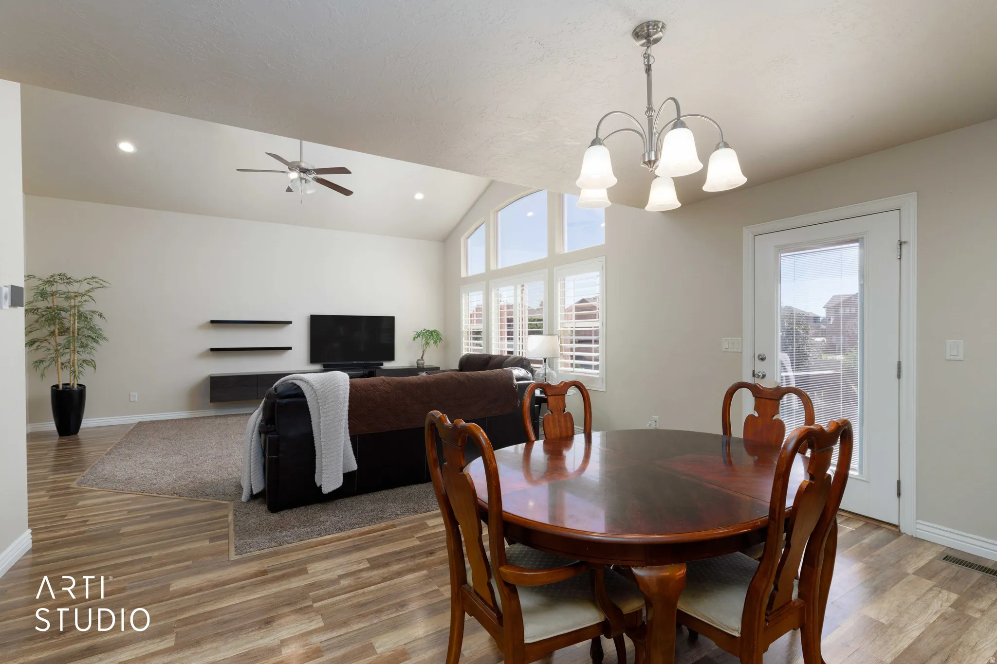 Vaulted ceilings with recessed lighting complement the wood-finish flooring