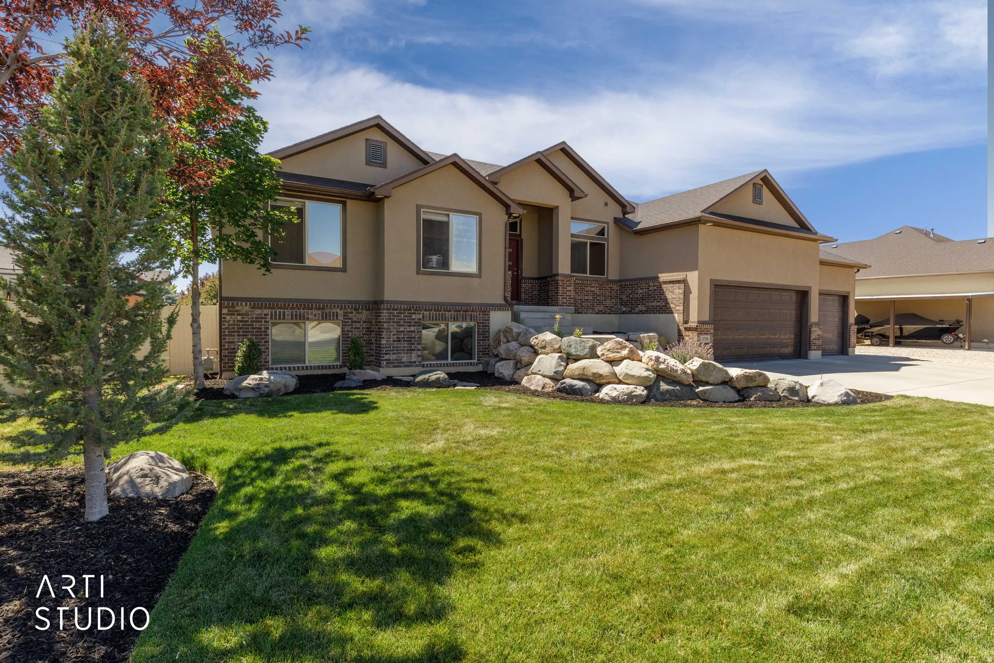 Stucco and stone facade property with a multi-car garage