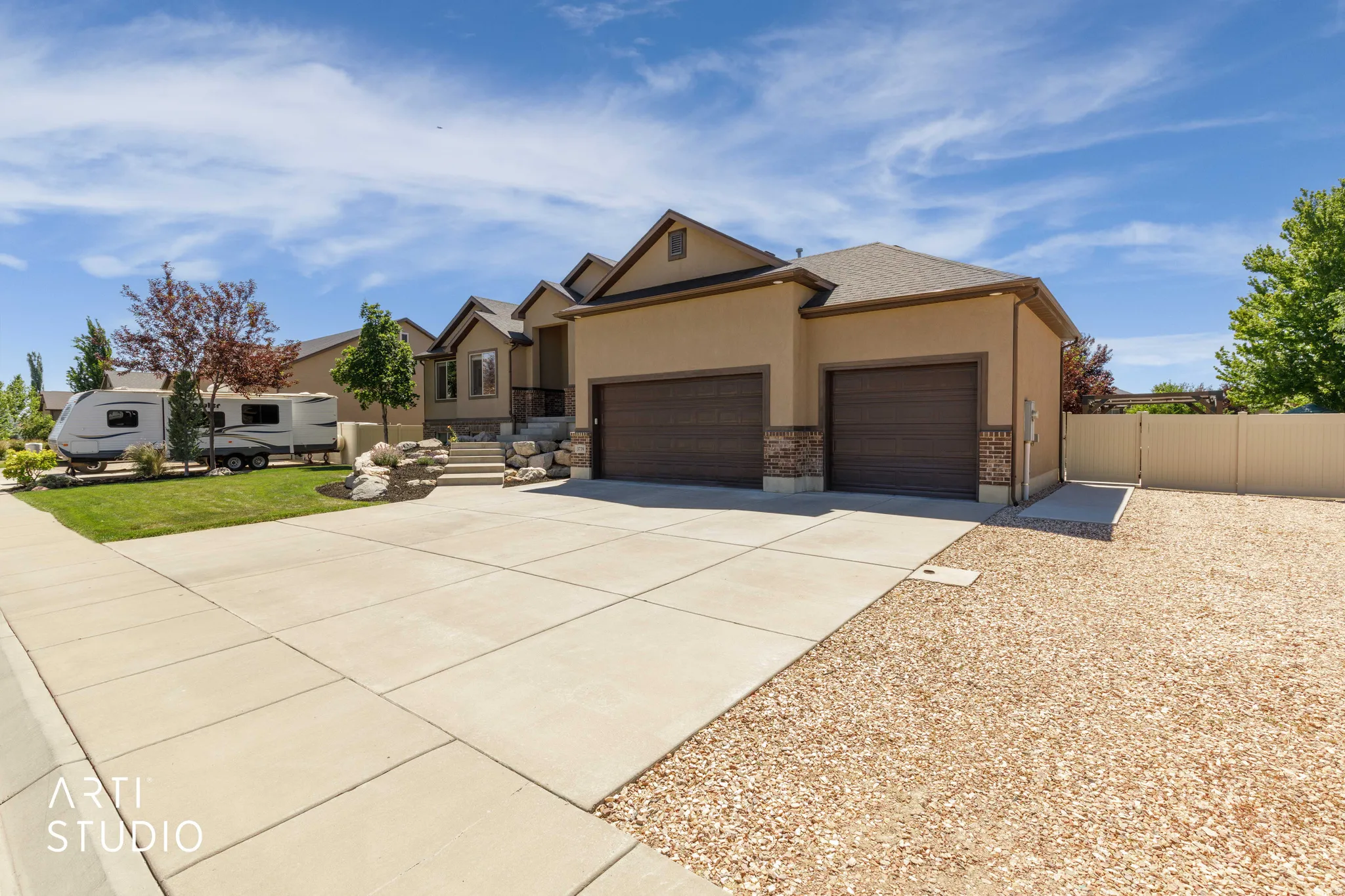 Stucco exterior with stone accents and a two-car garage