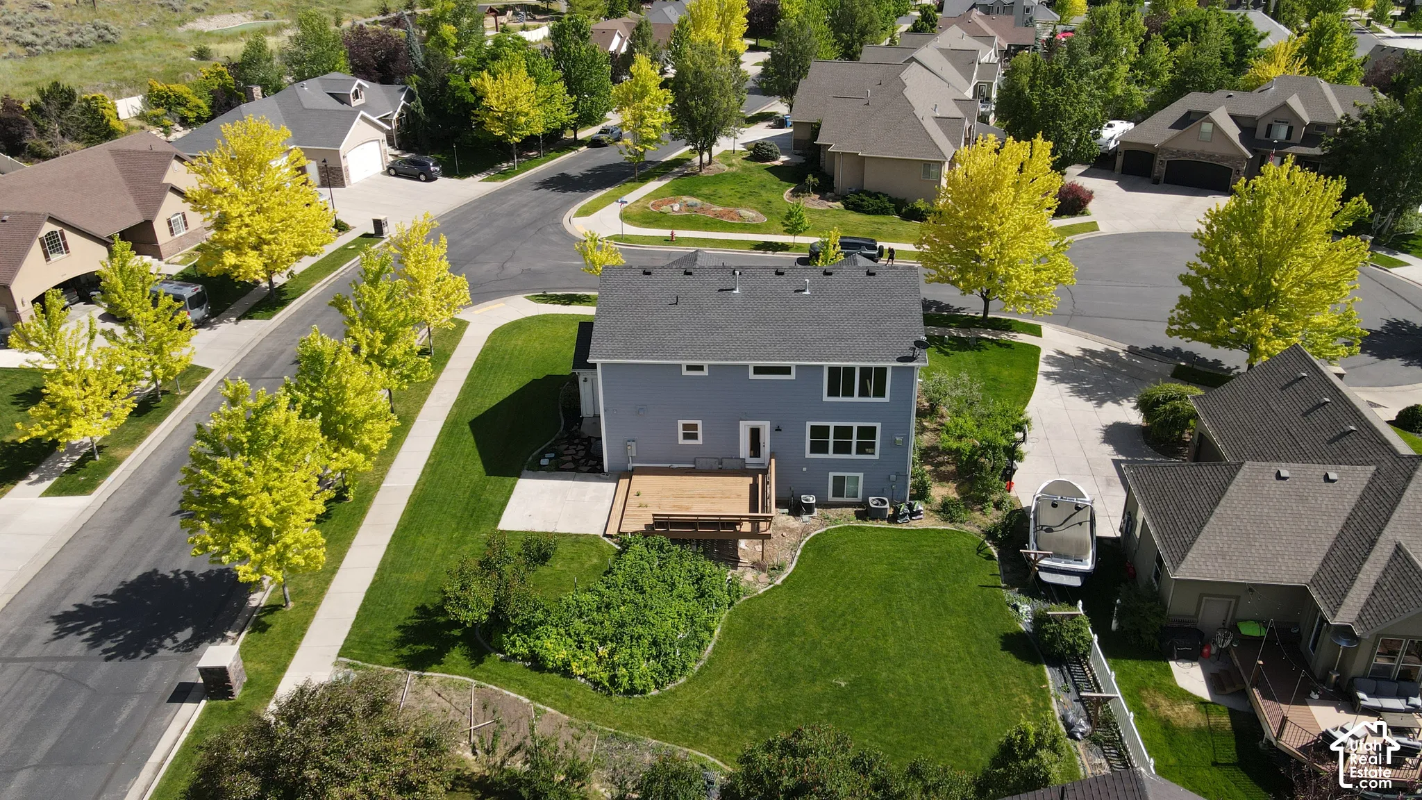 Two-story residence featuring a gray exterior and a shingle roof