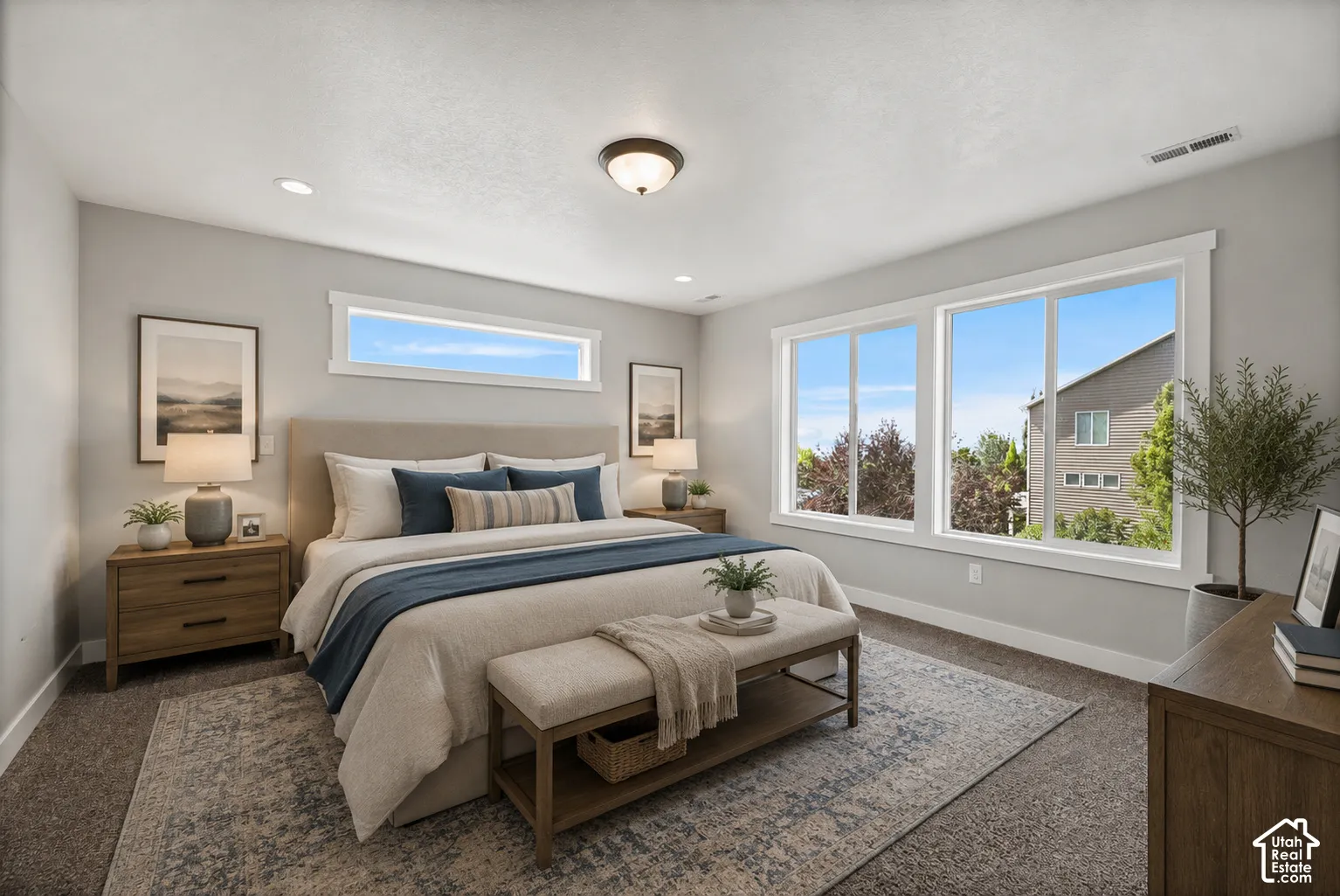 Carpeted sleeping area featuring a textured area rug, recessed lighting, and a neutral color palette