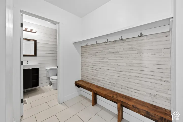 Built-in hall tree featuring a rustic wood-finish bench and paneling