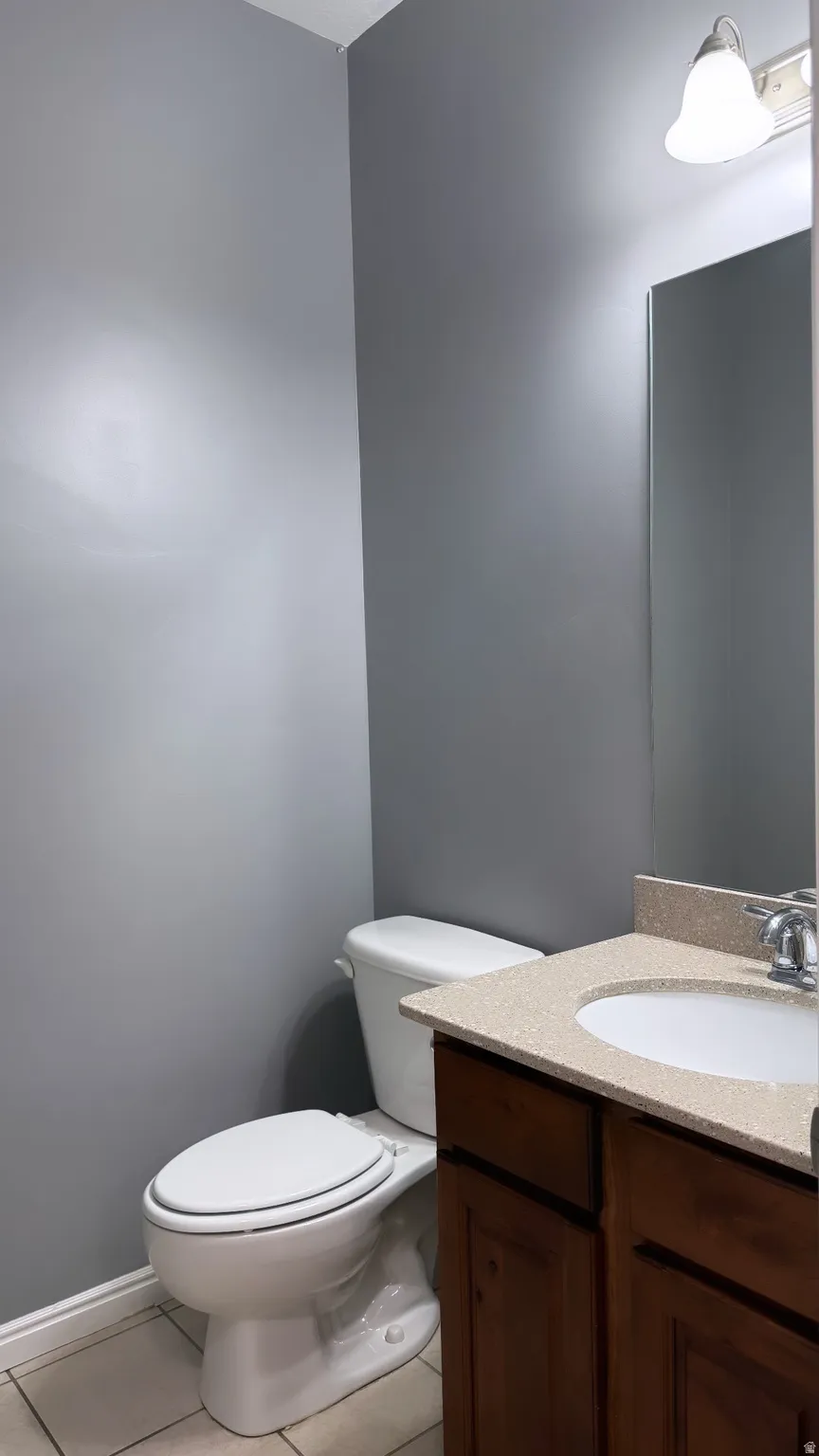 Bathroom featuring a single-sink vanity with wood-finish cabinetry and a speckled countertop