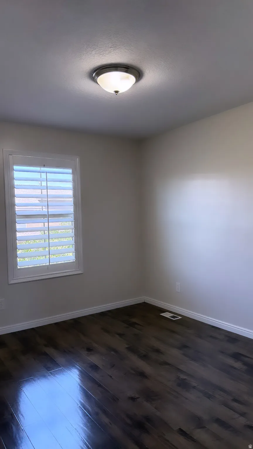 Wood-finish flooring with white trim throughout